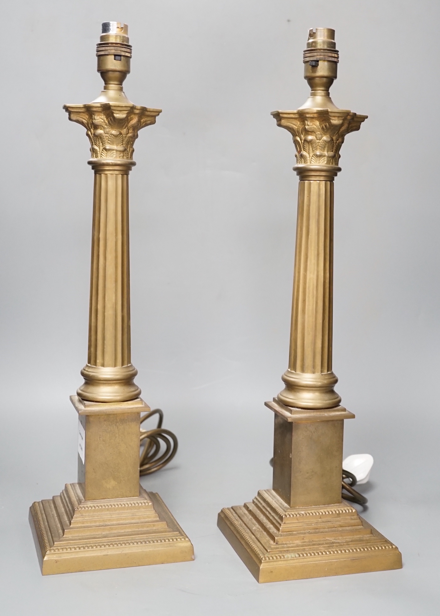 A pair of brass Corinthian column table lamps 48cm total